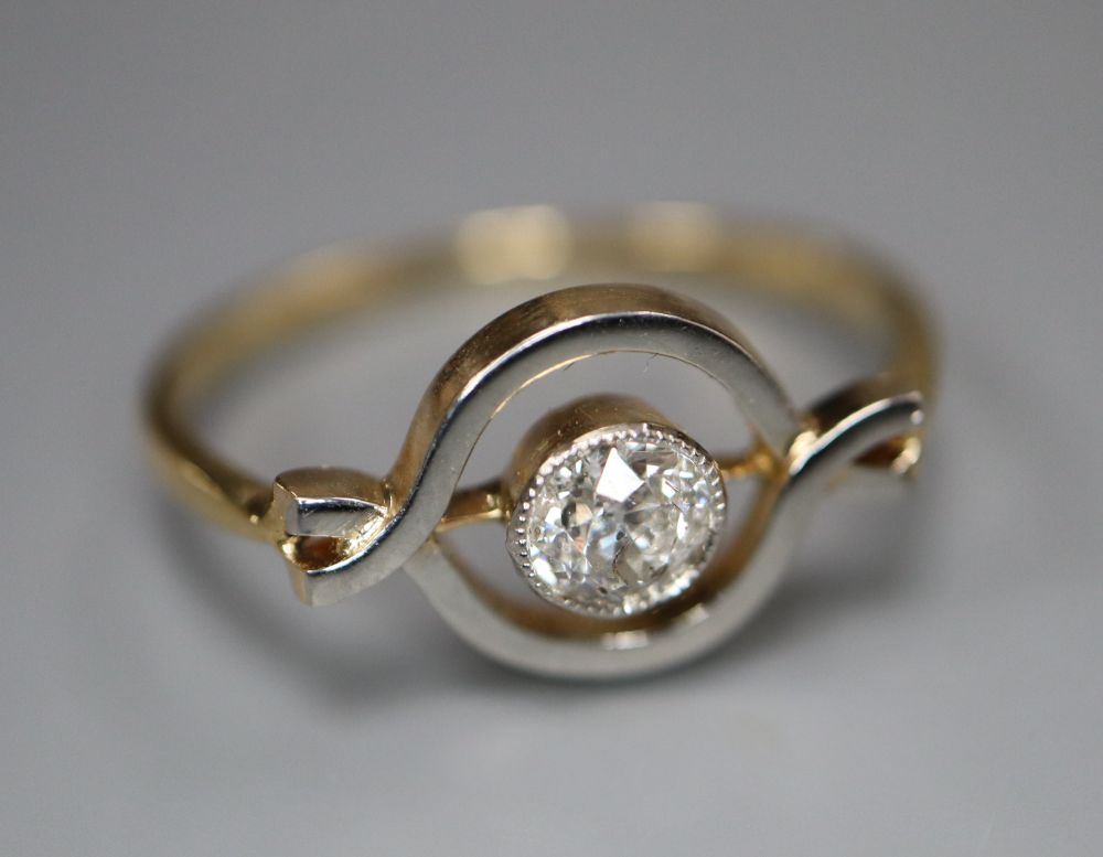 An 18ct and solitaire diamond set ring, in openwork setting, size M, gross 2.2 grams.